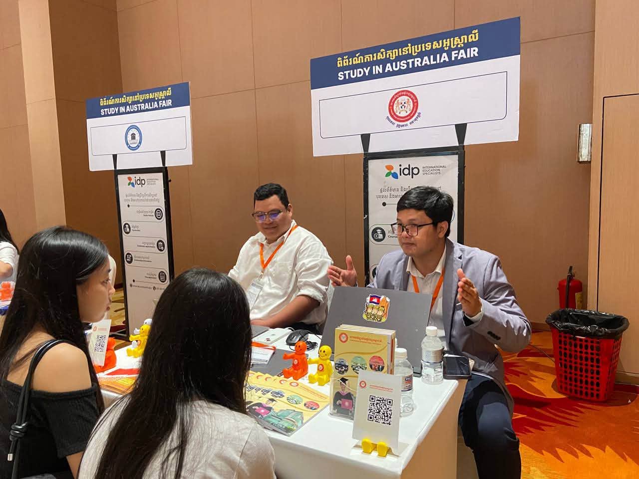 PPIU representatives speaking with visitors at an education fair